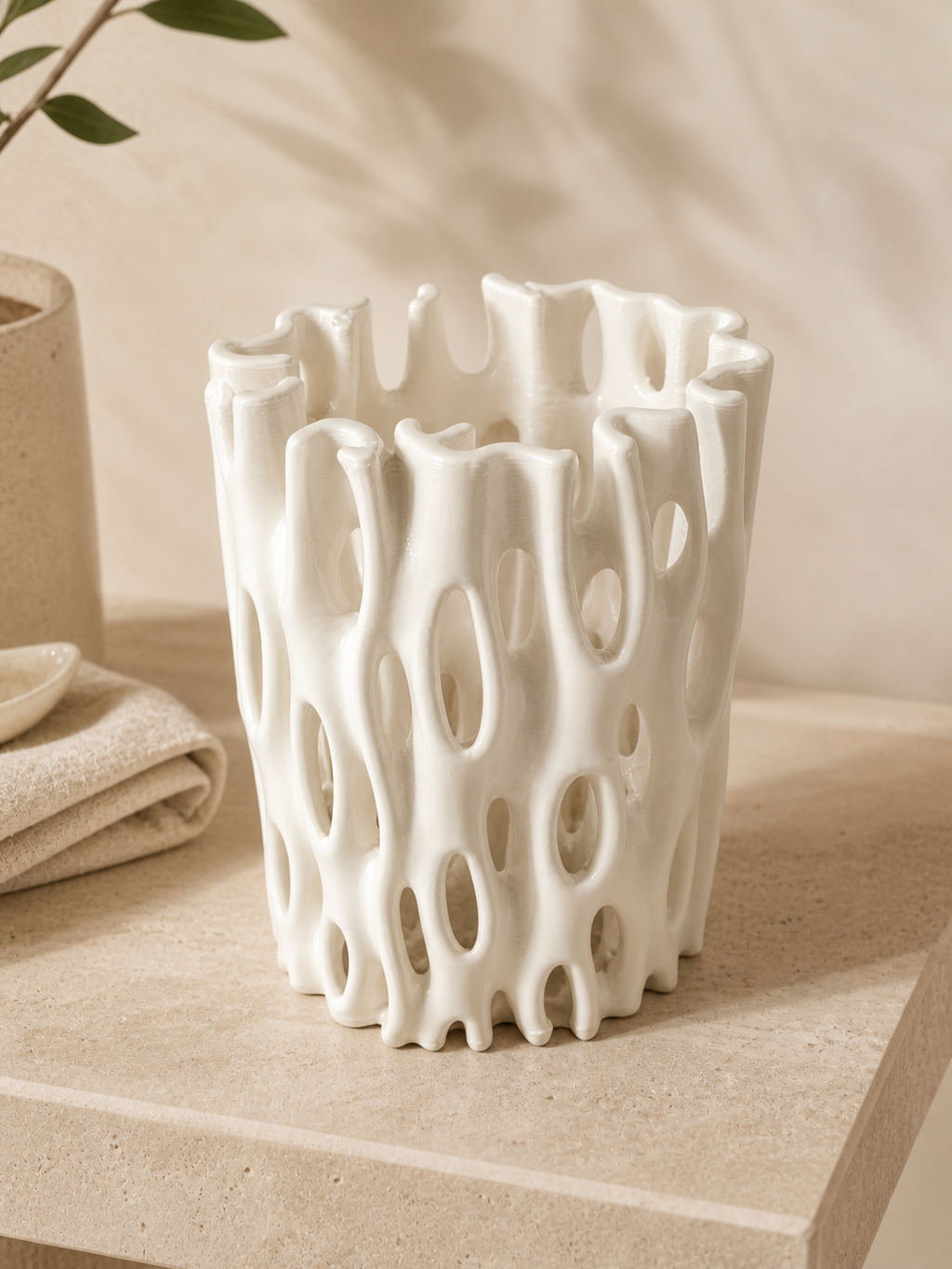 Coral Window Vase displayed on a warm stone shelf with soft neutral styling.