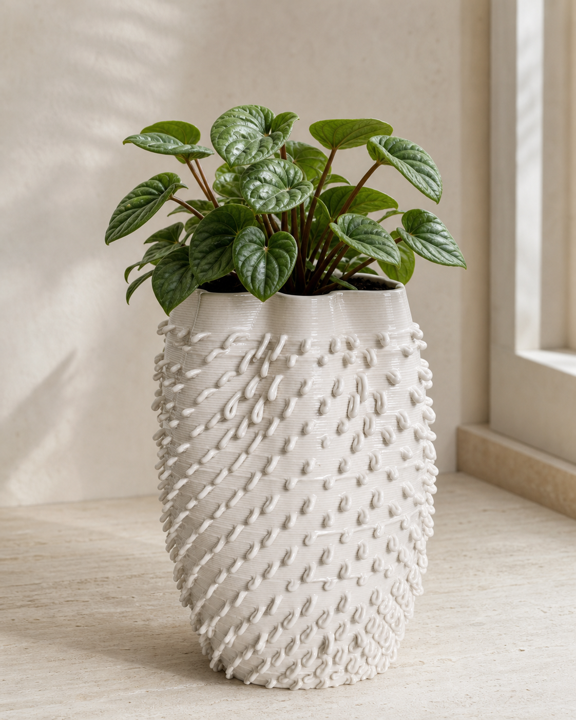 Rainfall Planter styled with a small green plant in a warm window-lit interior.