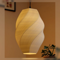 Warm ceramic pendant lamp with a woven shell texture.